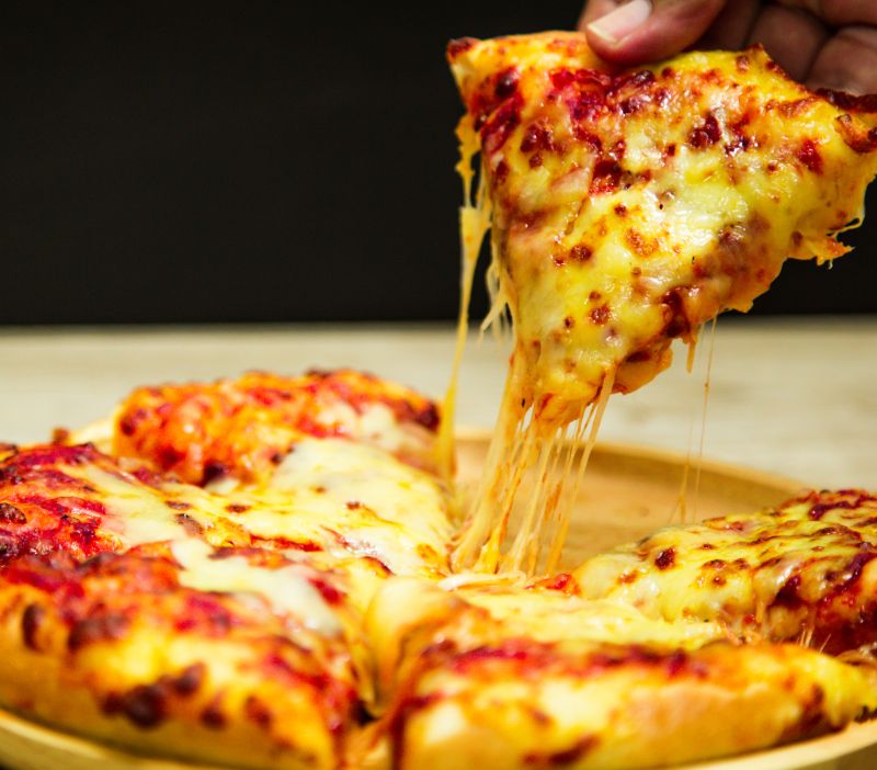 a slice of pizza being picked up